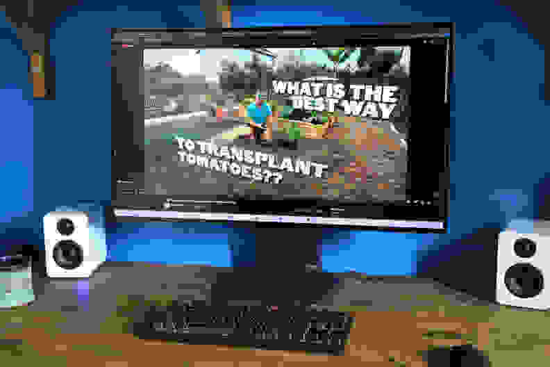 The LG Ultragear 32GS95UE-B monitor with a tomato transplanting guide on screen