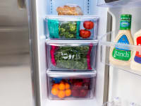 The Frigidaire FFSS2315TS's three crisper drawers, each filled with with fruits and vegetables.