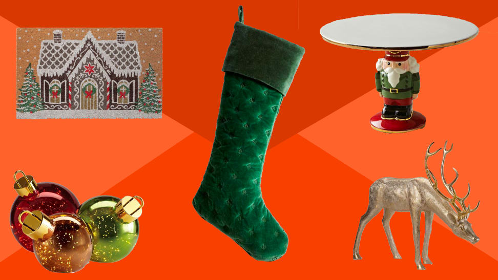 Holiday decorations on a red background, including ornaments, a stocking, a doormat, a dear and a cake plate