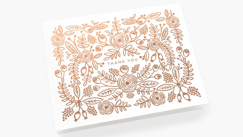 A thank you card with a metallic rose gold floral design.