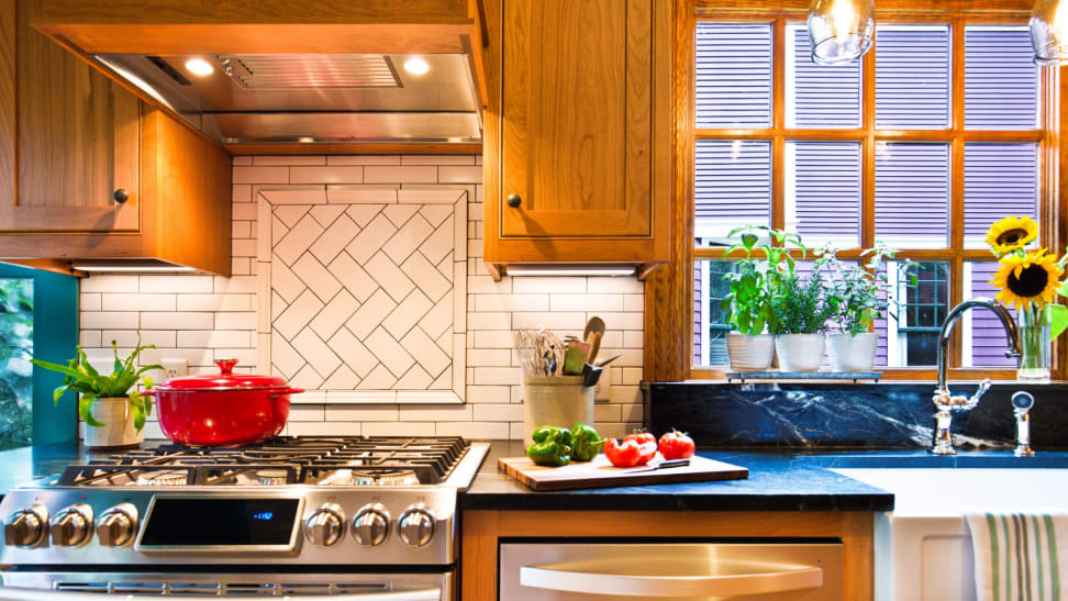 Modern kitchen with wooden cabinets and white tile backsplash.