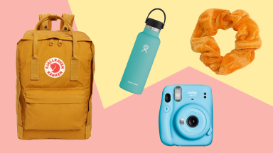 a yellow fjallraven backpack, blue hydroflask, blue instax fujifilm and scrunchie on a pink and yellow background