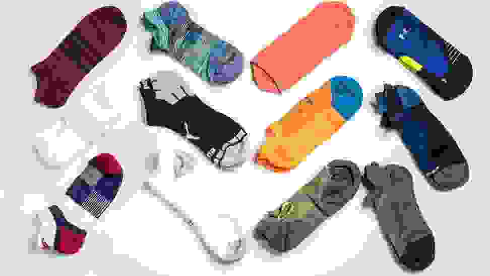 An array of unisex running socks from brands like Nike, Puma, and Saucony.