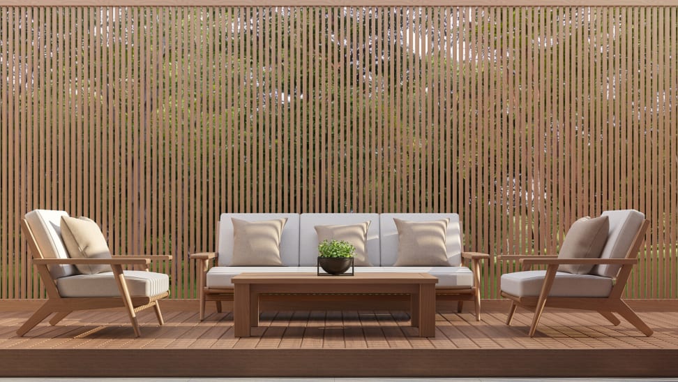 A patio with a matching couch, two chairs, and coffee table