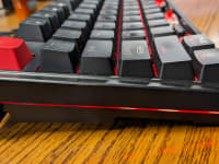 Side view of the Keychron C3 Pro gaming keyboard with black keys and red ESC key.