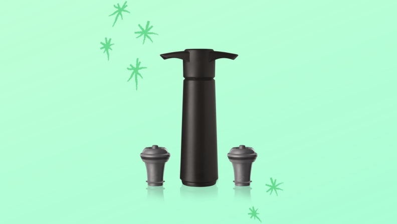 A VacuVin vacuum pump and two rubber corks against a green background with hand-drawn stars