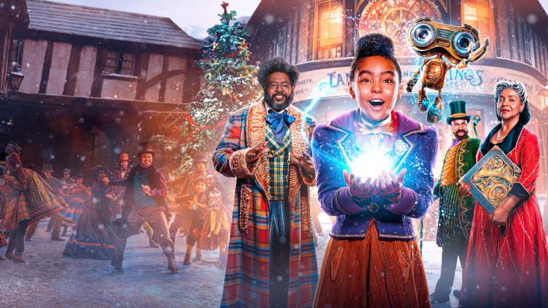 Anika Nony Rose plays Jessica in Jingle Jangle: A Christmas Journey (2020), holding a magical creation in front of a cast of Forest Whitaker, Keegan-Michael Key, and Phylicia Rashad.