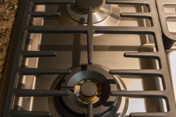 Linear grates on left side of cooktop