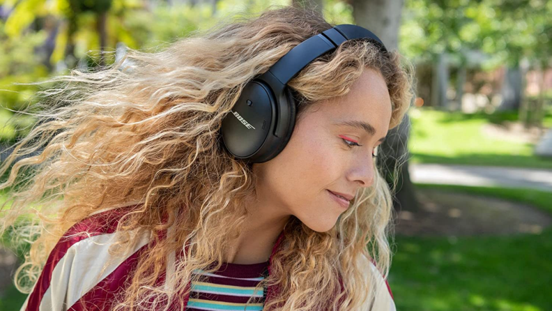 Person wearing over the ear headphones.