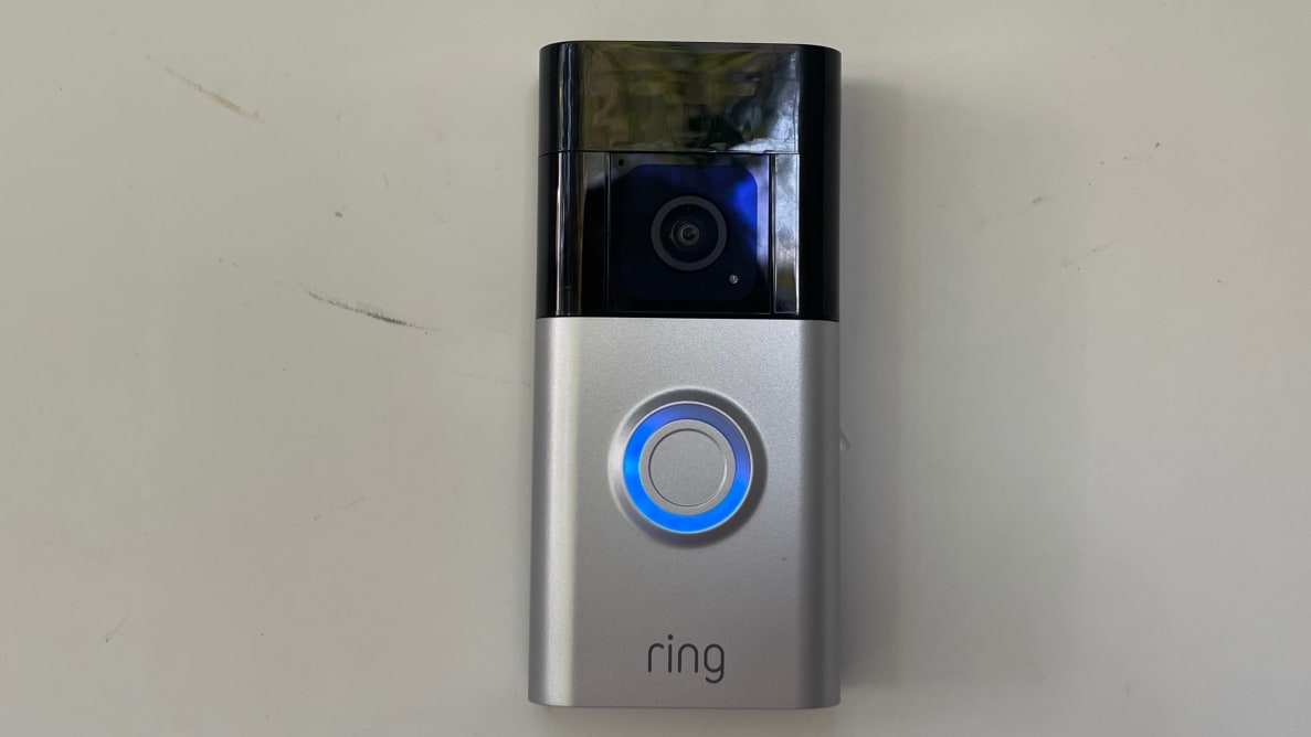 Ring Battery Doorbell Plus hanging on a front door