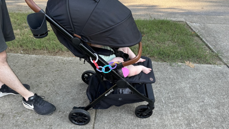 Baby in the Bombi Bebee stroller with the canopy down