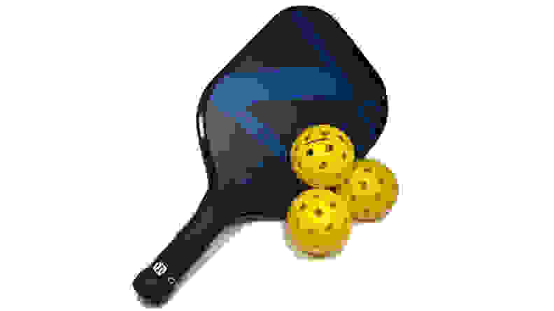Pickleball racket with three yellow pickleballs on white background