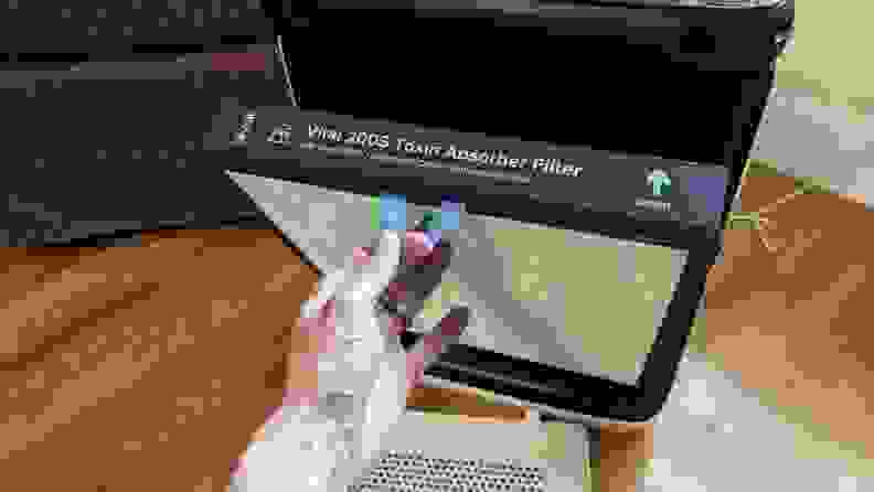 A hand holding a filter.