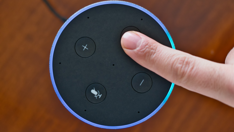 A person activates a voice assistant on a smart speaker.