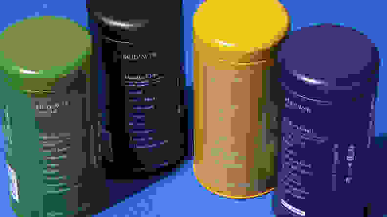 Four containers of Mud/Wtr in the colors green, black, yellow, and blue.