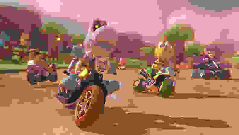 A bunch of characters from the Mario franchise zoom by on motorcycles and go-karts.
