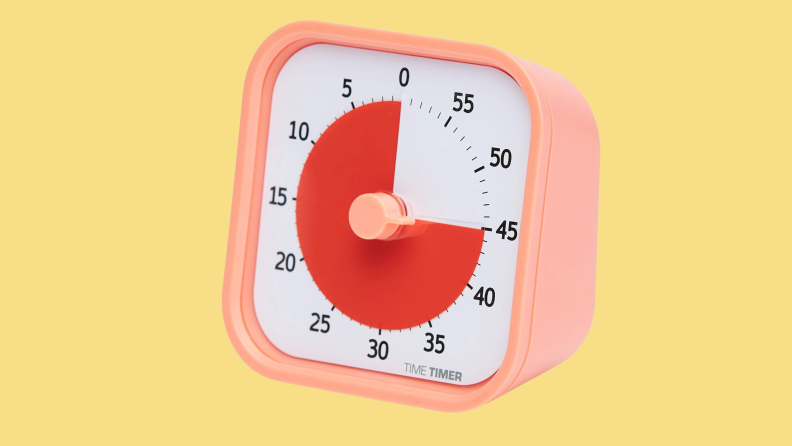 A pink, red, and white timer clock on a yellow background.