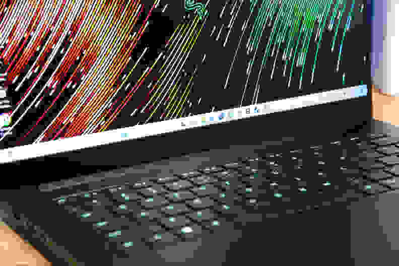 A close up of a black laptop's keyboard and part of its screen.