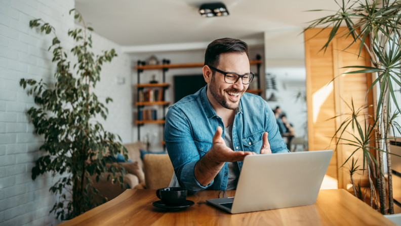 Smiling person on video chat using a computer