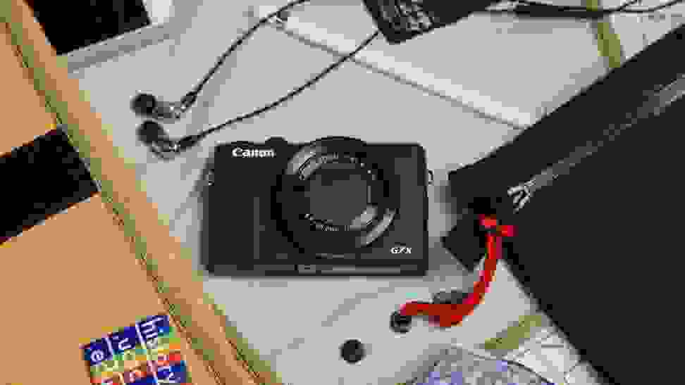 A Canon camera outside of a messenger bag