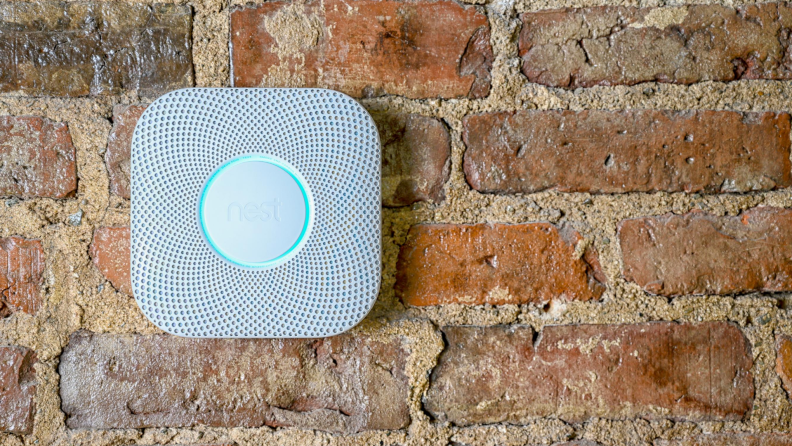 Smoke and carbon monoxide combination detector mounted on a brick wall