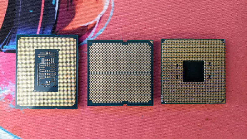 Three computer processors lined up on a mat.