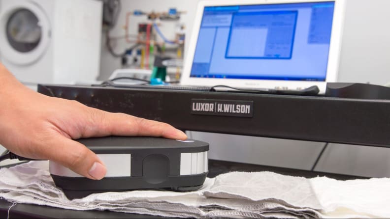 A spectrophotometer scanning a stain strip.