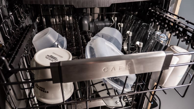 A close-up of the GE Café CDT875M5NS5 dishwasher's middle rack, with some dishes, bowls, and glasses loaded up.