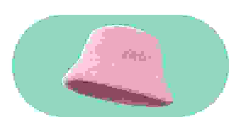 A model wearing a fuzzy pink bucket hat.