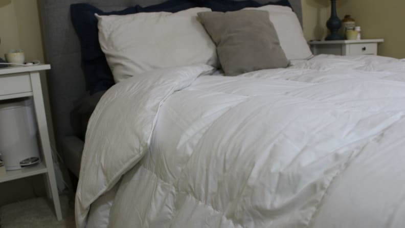 A bed made with a white comforter