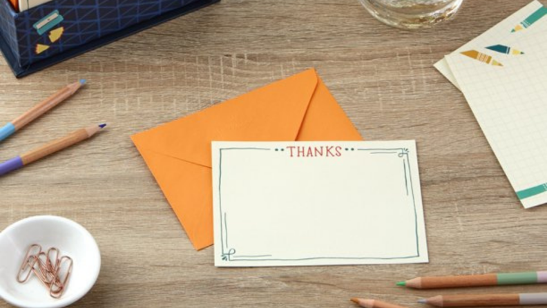 A thank you note on a table surrounded by thank you notes.
