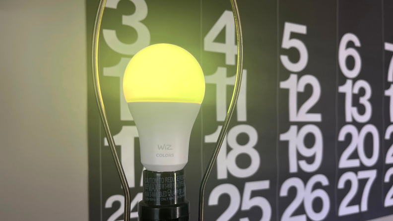 The Wiz smart bulb displayed in yellow light