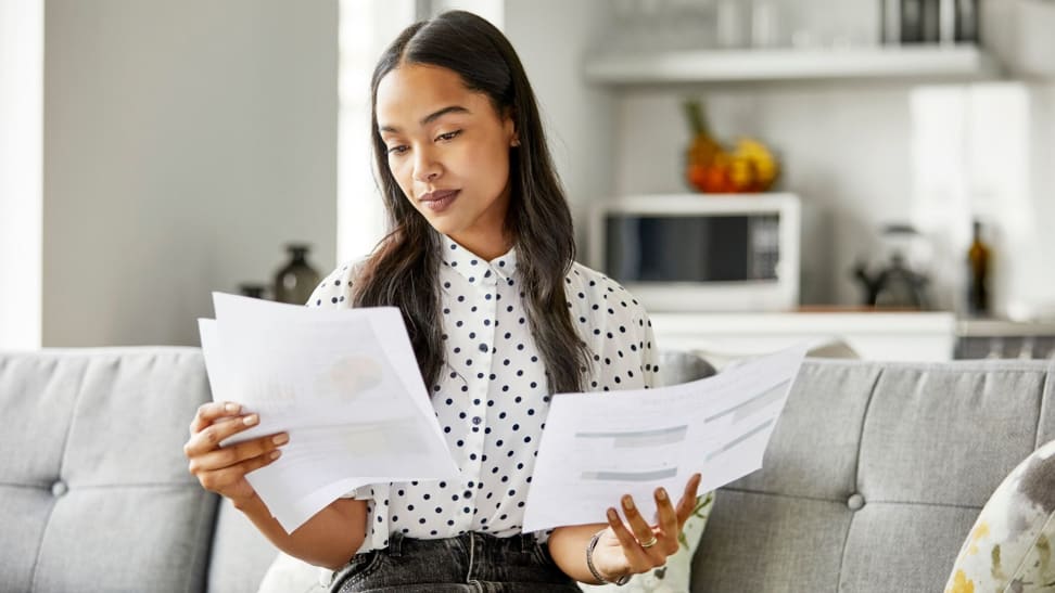 A woman looking at her credit report compiled by a credit bureau