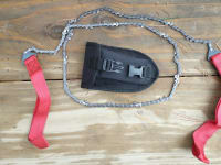 Pocket-sized chainsaw on wooden surface.