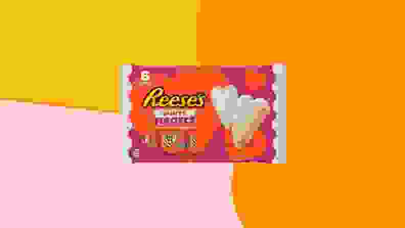 Reese's White Creme Hearts packaging on an orange, yellow, and pink background