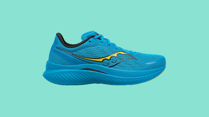 A blue sneaker against a teal background.