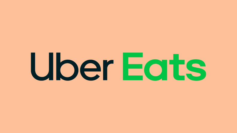 Uber Eats logo against peach background