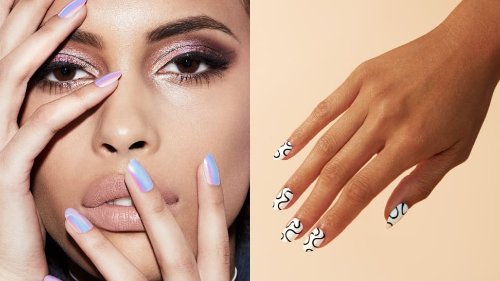 On the left: A woman wearing dramatic makeup stares at the camera and holds her holographic blue nails from Static Nails up to her face. On the right: A hand comes from the upper right corner of the frame pointing down toward the left corner of the frame wearing white Chillhouse nails with black squiggles on them.