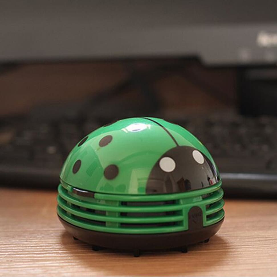 This adorable ladybug vacuum cleans tables and desks.