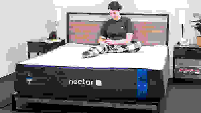 A person sitting on a Nectar mattress.