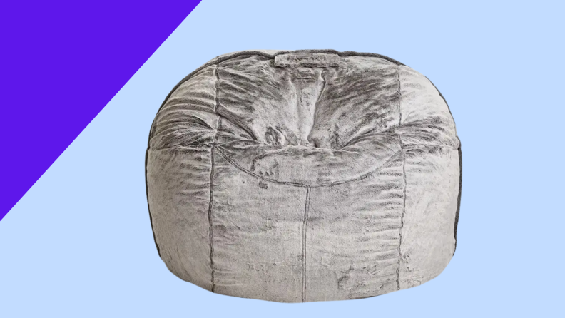 A gray bean bag on a blue background
