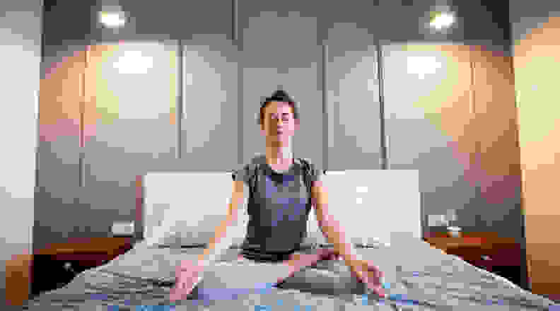 Person meditating in bed