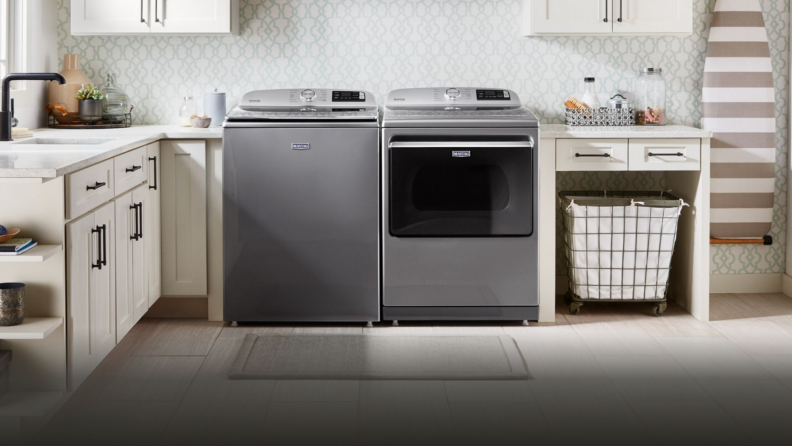 Maytag washer and dryer set inside of modern laundry room in home.