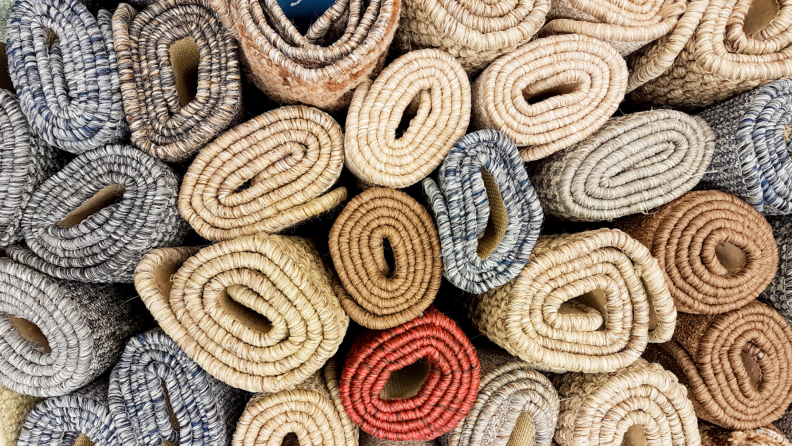 Close-up of a stack of rolled up area rugs