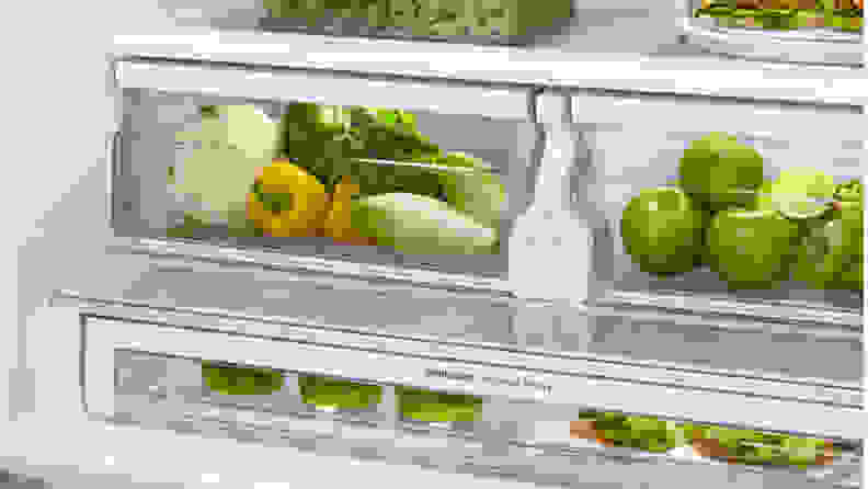 Two crispers side by side, one containing vegetables and one containing fruitis.