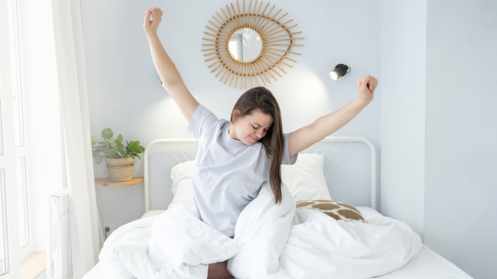 A person sitting in bed stretching