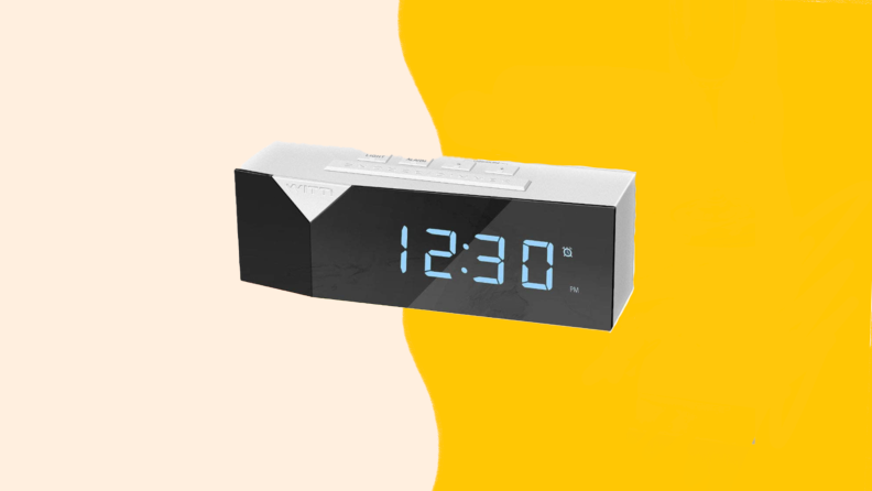 White rectangular alarm clock with LED display.