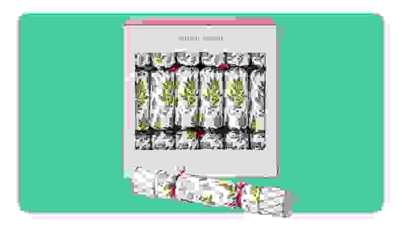 A box of Williams Sonoma Christmas crackers in front of green background.