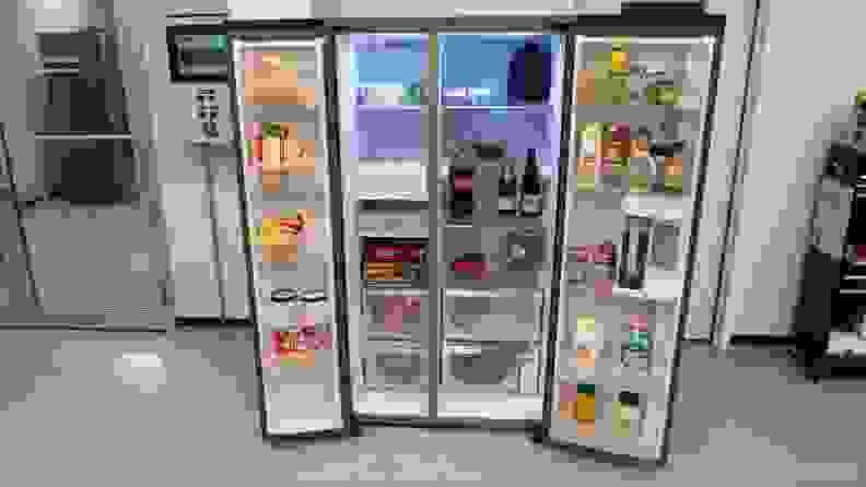 Samsung RS28CB7600 side-by-side Bespoke refrigerator with both doors open to reveal assorted foods on each shelf and inside of both doors.