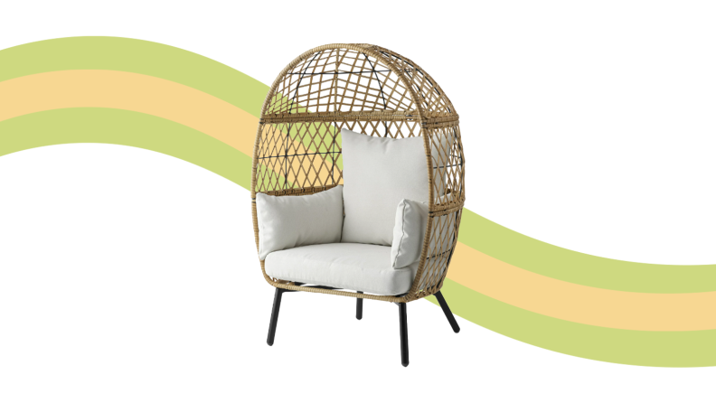 A wicker egg chair surrounded by a strip of green and orange.